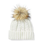 Cappello con pompon e toppa in pelle